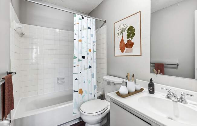 a bathroom with a white toilet next to a bath tub