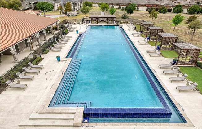 swimming pool with sundeck and lounge chairs at Villages 3Eighty apartments