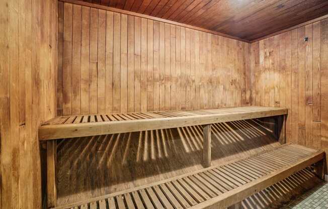 A wooden bench in a room with wooden walls.
