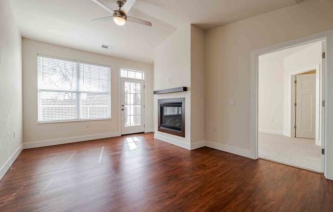 A room with a wood floor and a ceiling fan.