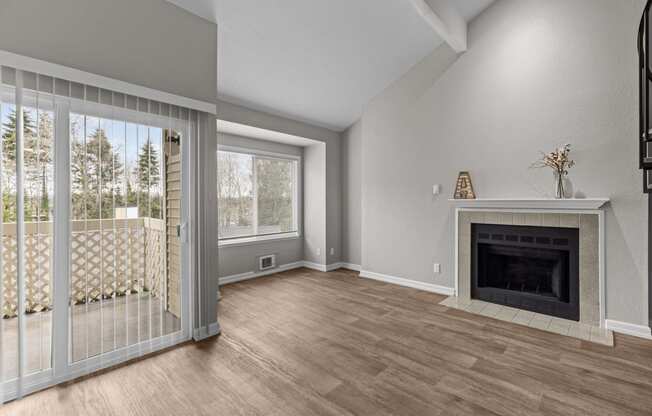 a living room with a fireplace and a sliding glass door