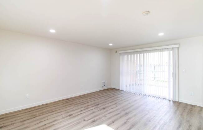 Living room with natural light and window blinds in Redmond, WA apartment