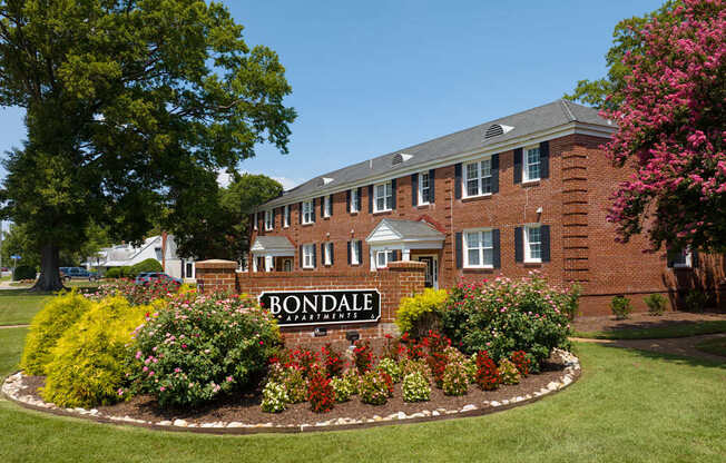 A brick building with a sign that says Bondale in front of it.
