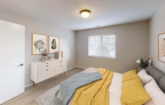 Spacious bedroom with a large window letting in natural light.