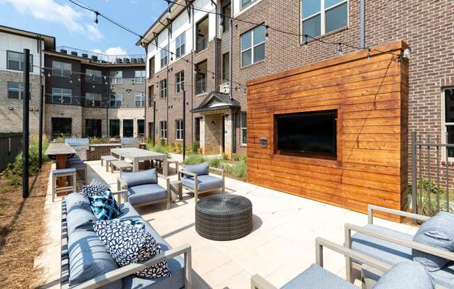 an outdoor patio with furniture and a tv