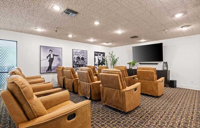 A room with a carpeted floor and a row of brown chairs.