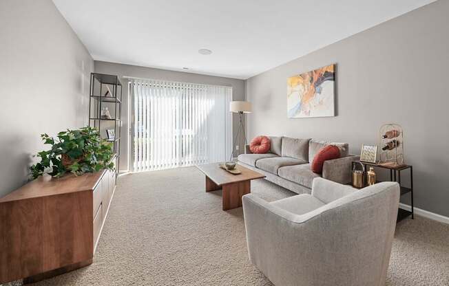 Spacious Living Room with Sliding Glass Door at Lakeside Village Apartments Clinton Township MI