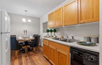 kitchen with wood cabinets and dining room