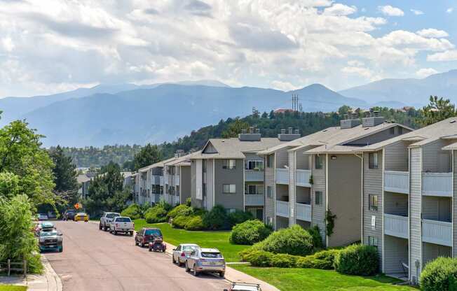 Apartment buildings on a street with mountains in the background  at Union Heights Apartments, Colorado Springs, CO