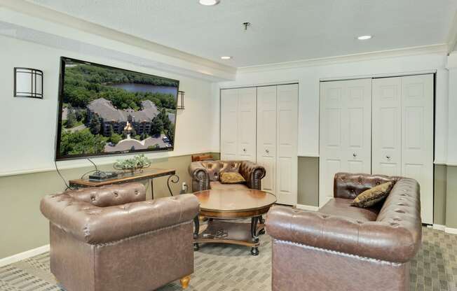 a living room with leather couches and a table