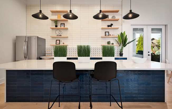 a kitchen with a white counter top and blue tiles at Sovereign at Overland Park, Overland Park, KS  