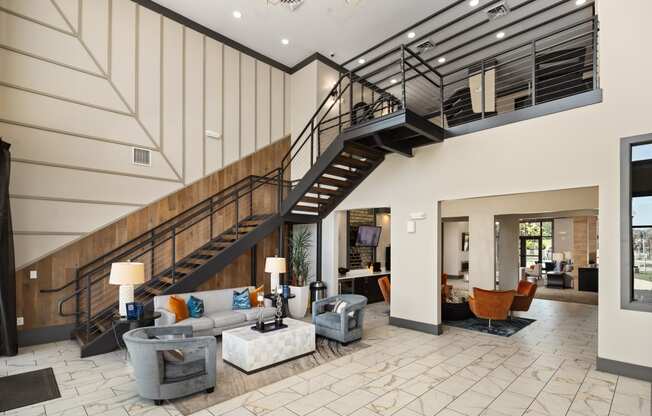 a living room with couches and a staircase