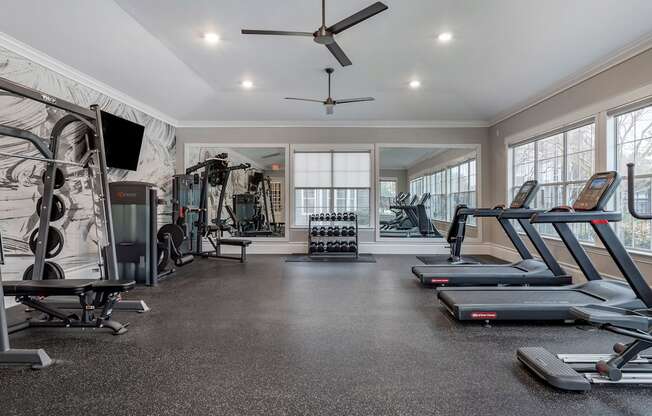 the gym has treadmills and other exercise equipment and windows at Reserve by the Lake, Houston, Texas