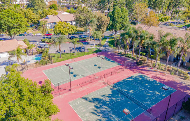 a tennis court at the resort with palm trees