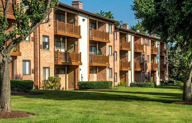 A large apartment complex with a green lawn in front.