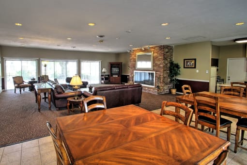 a living room and dining room with a table and chairs