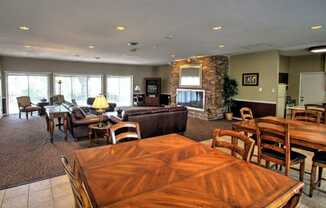 a living room and dining room with a table and chairs