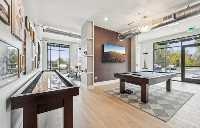 a billiards room with a pool table and a large window at The Quarry Luxury Apartment Homes, Colorado, 80526