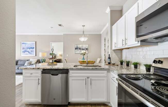 a kitchen with white cabinets and a counter top