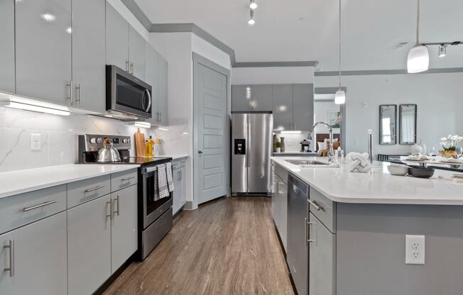 Kitchen gallery with white cabinets  at Reveal Skyline  at La Cantera, Texas