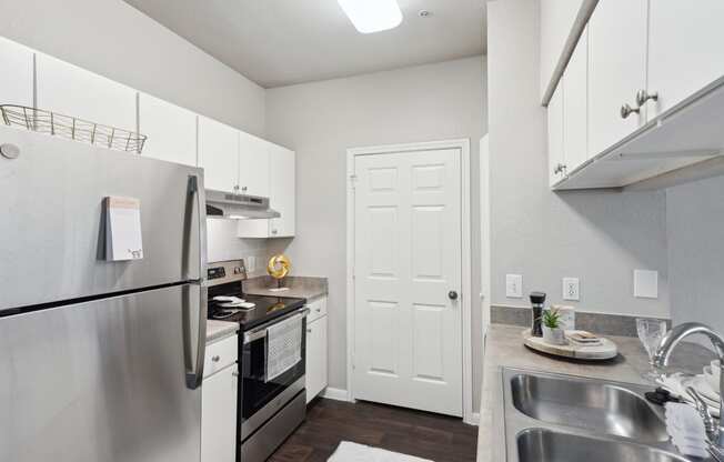 a kitchen with stainless steel appliances and white cabinets