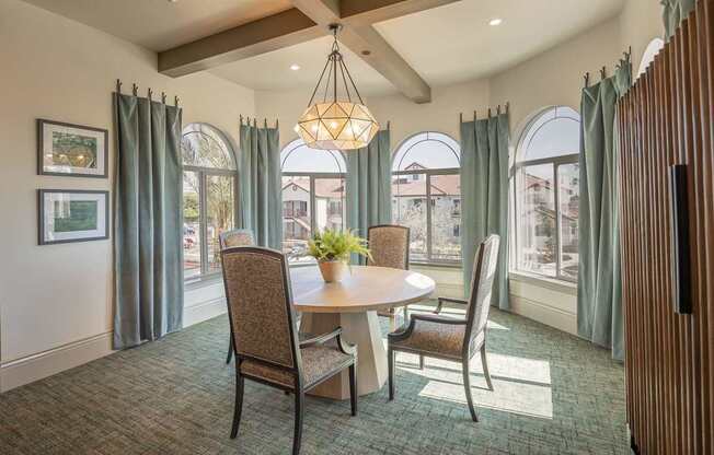 A dining room with a table and chairs.