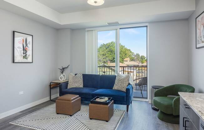 a living room with a blue couch and a green chair