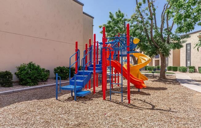 Phoenix, AZ apartments - Monaco31 - Playground surrounded by trees and bushes