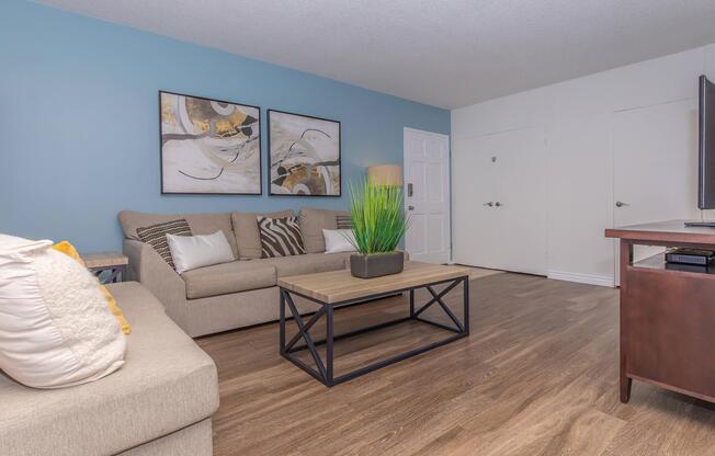 a living room filled with furniture and a flat screen tv