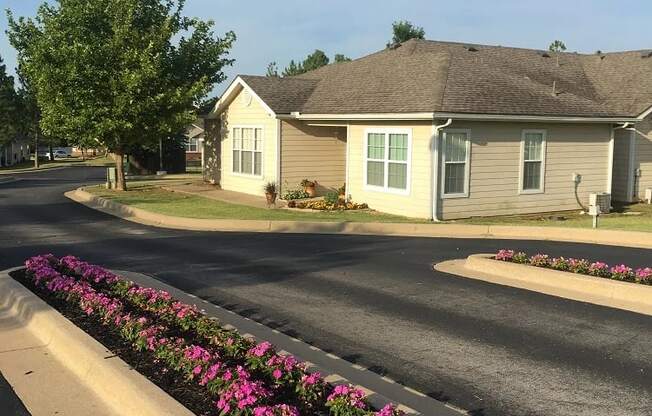a house on a street with a flower bed in front of it at EDGEWOOD AT GABLES Apartments, TULSA