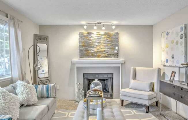 A modern living room with a fireplace and a grey sofa.