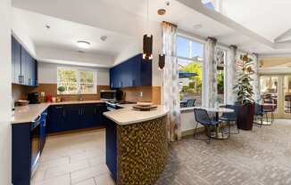 a kitchen with blue cabinets and a table with chairs