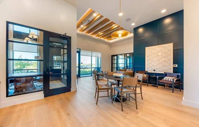 A modern living room with a glass door leading to a balcony.
