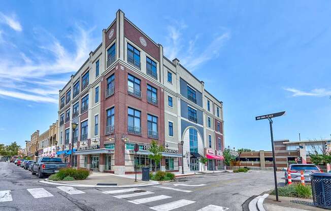 A street view of a multi-story building with a clear blue sky above.