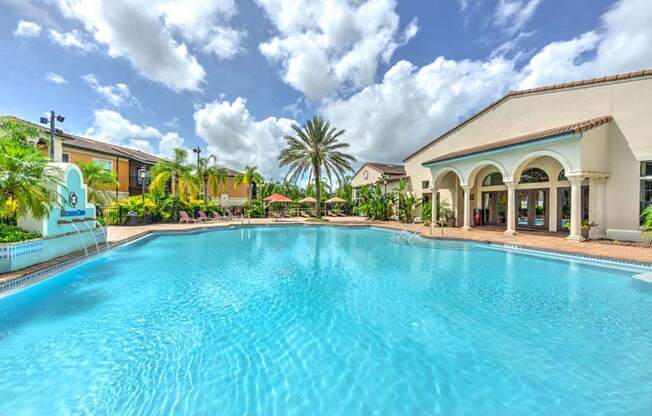 a large swimming pool with a building in the background  at Hacienda Club, Jacksonville, FL