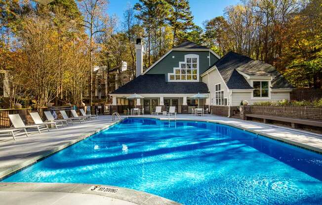 a swimming pool with a house in the background