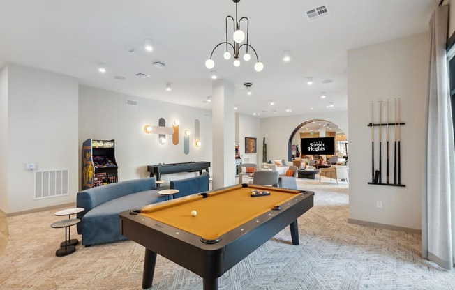 a game room with a pool table and a tv