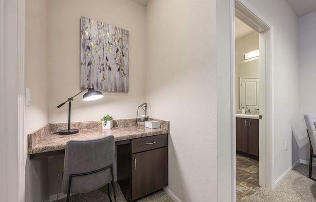 A room with a desk and chair in it.