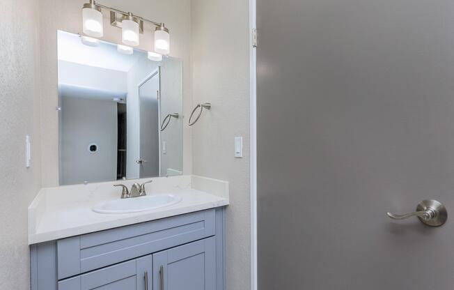 a room with a sink and a mirror