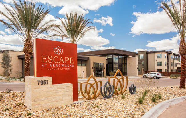 A sign for Escape at Arrowhead stands in front of a building.