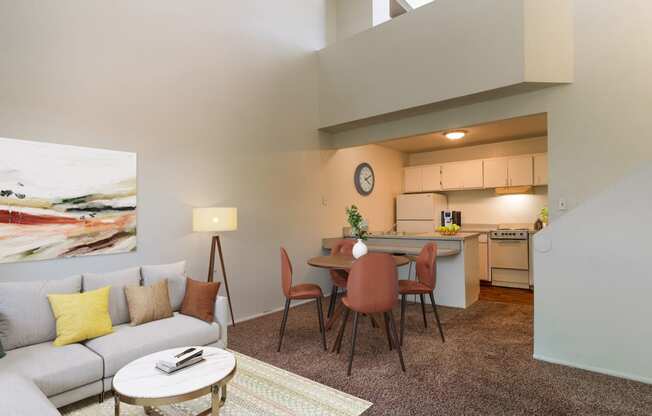 a living room with a couch and a table and a kitchen