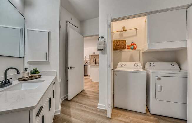 A white laundry room with a washer and dryer.