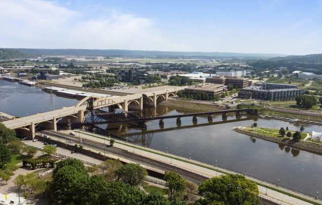 an aerial view of a bridge over a river in a city