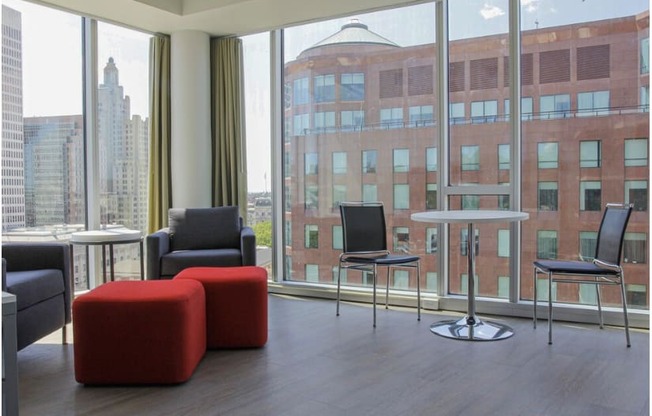 a living room with chairs and a table and a large window