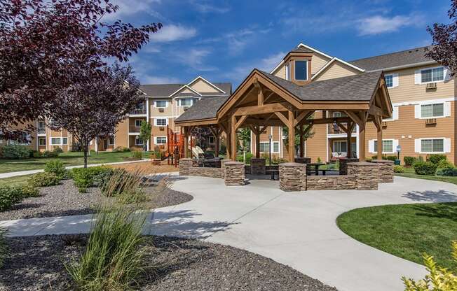 a pavilion with a sidewalk in front of an apartment building
