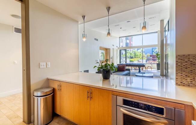 A modern kitchen with wooden cabinets and a stainless steel oven.