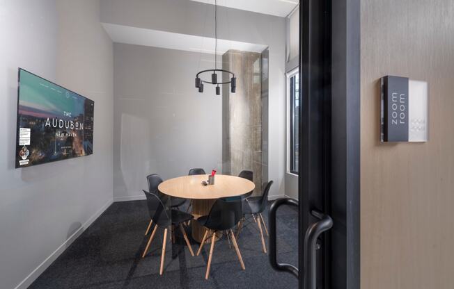 a dining room with a wooden table and chairs