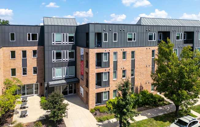 A modern building with a parking lot in front.