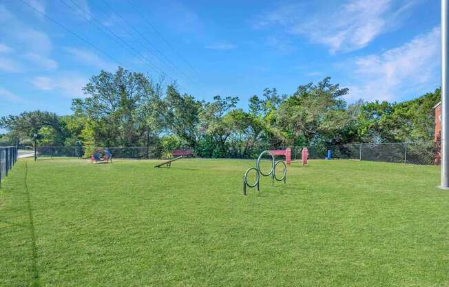Grassy field with a playground at Great Hills, Austin, 78759