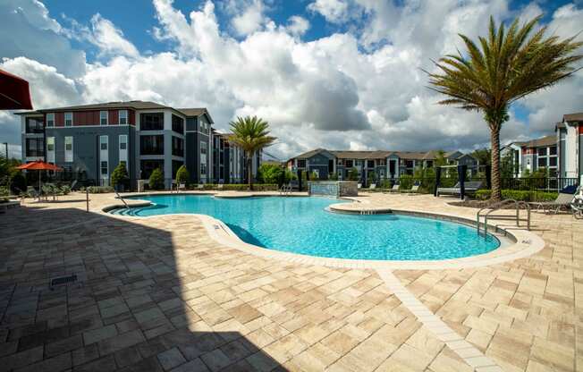 a large swimming pool in front of an apartment building